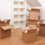 Empty room full of cardboard boxes for moving into a new home.
